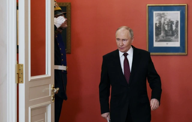Russian President Vladimir Putin arrives to make a statement to the media at the Kremlin in Moscow