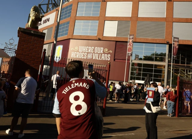 Aston Villa fan wears a Youri Tielemans shirt outside the stadium