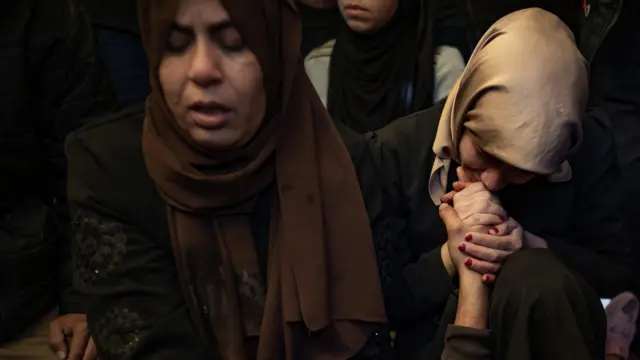 Mourners gather at the funeral of a Palestinian journalist killed in Gaza