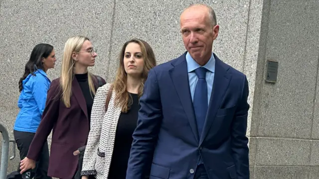 A group of lawyers file out of a Manhattan courthouse.