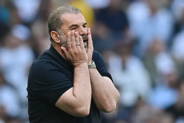 Ange Postecoglou with his hands on his face