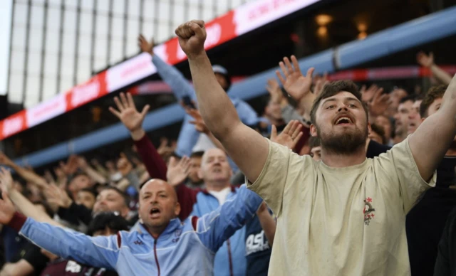 Aston Villa fans react in the stands
