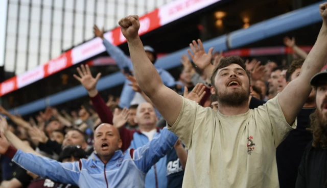 Aston Villa fans react in the stands
