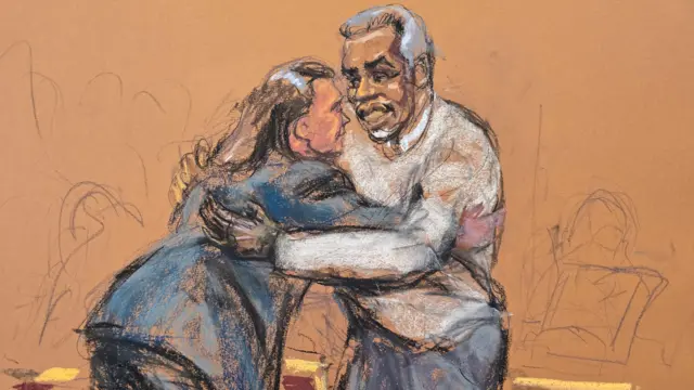 Diddy hugs his lawyer in the courtroom