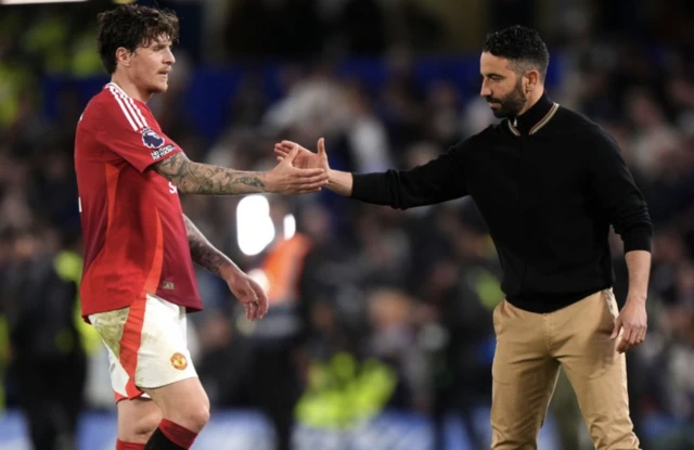 Manchester United's Victor Lindelof greets manager Ruben Amorim