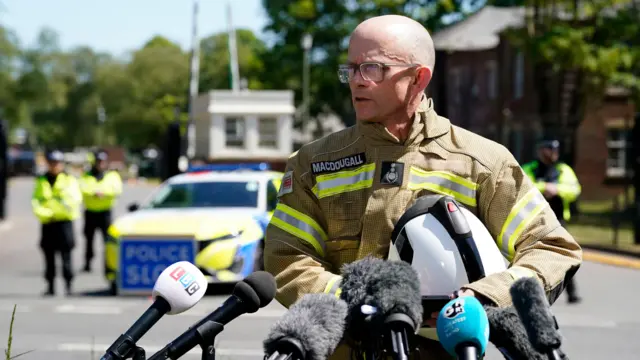 Oxfordshire Fire and Rescue Service Chief Fire Officer, Rob MacDougall, speaks to the media outside at Bicester Motion