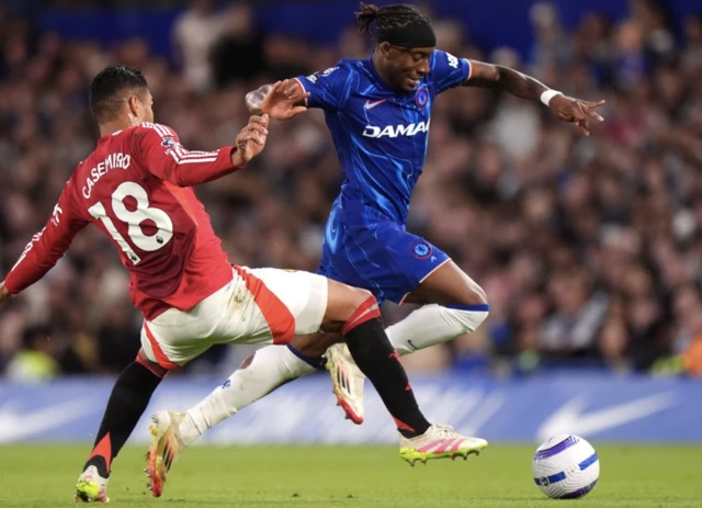 Manchester United's Casemiro (left) challenges Chelsea's Noni Madueke