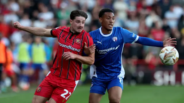 Walsall's Jamie Jellis and Chesterfield's Lewis Gordon battle for the ball