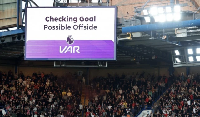 A big screen displays a VAR review message