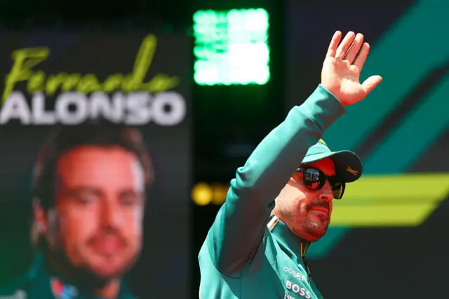 Fernando Alonso waves to the crowds