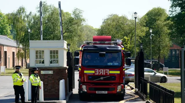 A fire truck is parked in front of the site of Bicester Motion. two officers dressed in green high vis are off to the side