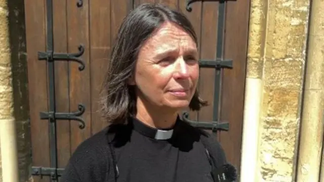 The Reverend Sarah Mortimer standing outside the church door