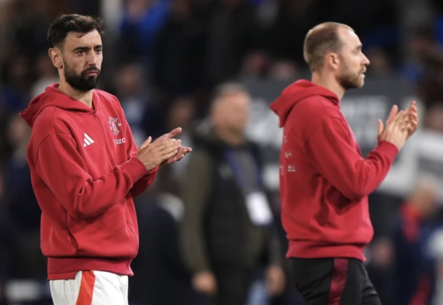 Manchester United's Bruno Fernandes and Manchester United's Christian Eriksen applaud the fans