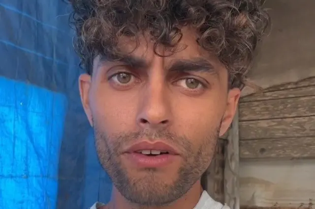 Adham speaks to the camera