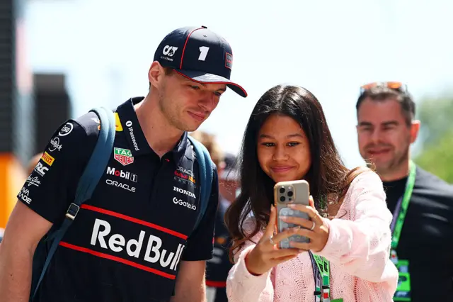 Max Verstappen takes a picture with a fan