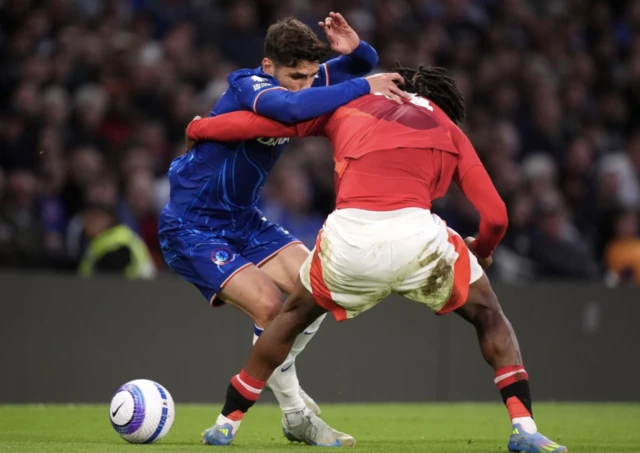 Chelsea's Pedro Neto and Manchester United's Patrick Dorgu battle for the ball