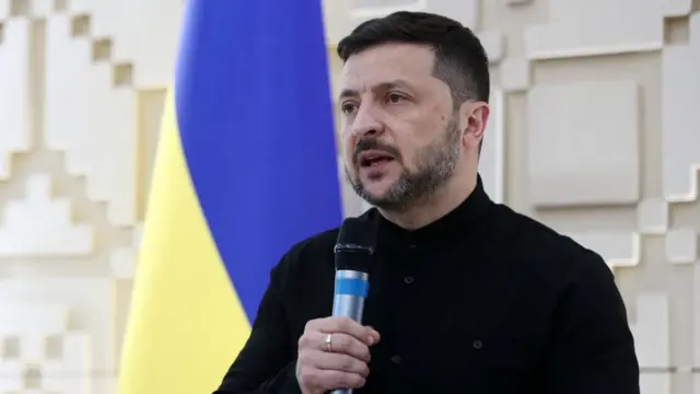 Zelensky holding microphone.