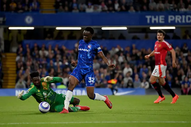 Tyrique George of Chelsea is challenged by Andre Onana