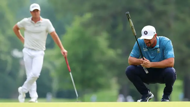 Bryson DeChambeau lines up a putt