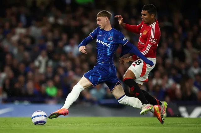 Cole Palmer (L) fights for the ball with Manchester United's Brazilian midfielder #18 Casemiro