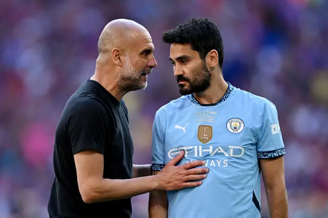 Pep Guardiola, Manager of Manchester City, interacts with Ilkay Gundogan