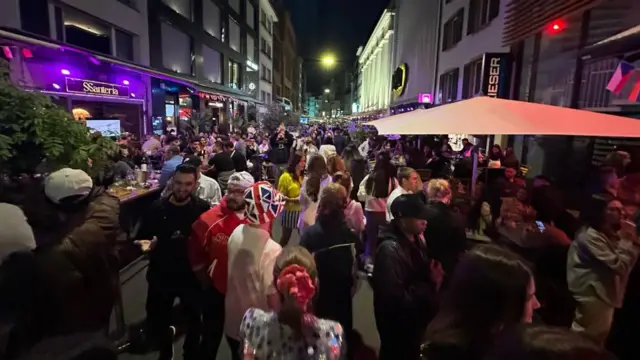 A crowd of people out on the streets