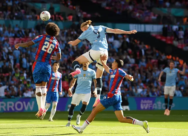 Erling Haaland of Manchester City is challenged by Chris Richards and Maxence Lacroix