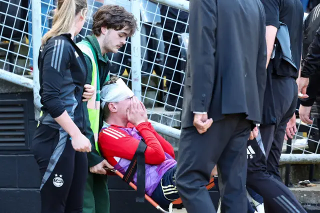 Aberdeen's Jack MacKenzie receives treatment after being hit with an object from the crowd during a William Hill Premiership match between Dundee United and Aberdeen at the CalForth Construction Arena at Tannadice Park,