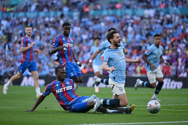 Bernardo Silva of Manchester City is fouled by Tyrick Mitchell