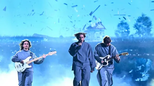 Lithuania entry for Eurovision Song Contest 2025 on stage in blue jumpsuits and instruments