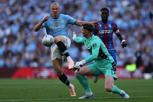 Dean Henderson uses his hand to knock the ball away