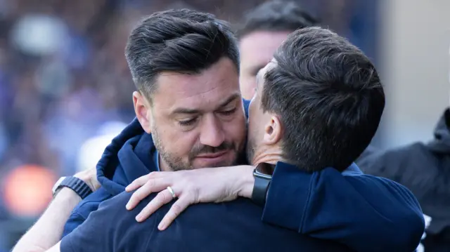 AFC Wimbledon boss Johnnie Jackson embraces Notts County counterpart Stuart Maynard after the final whistle