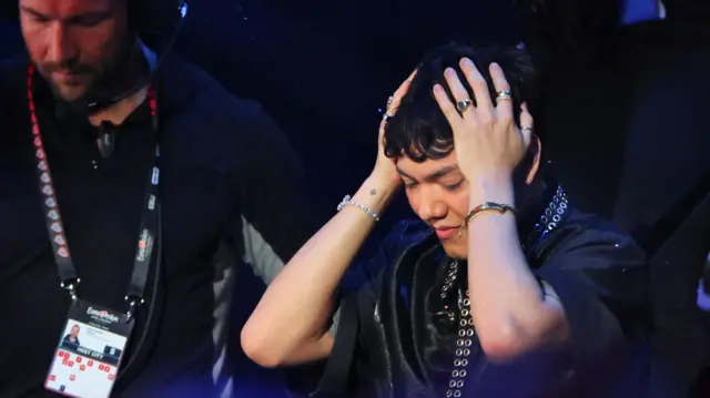 JJ puts their head in their hands