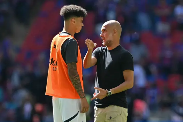 Pep Guardiola and Nico O'Reilly
