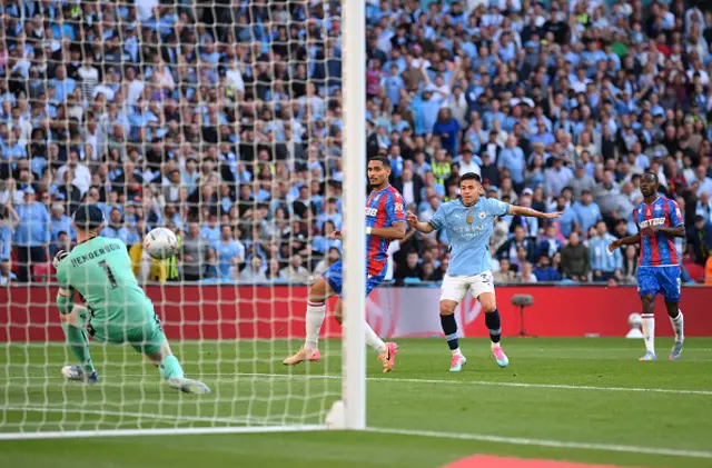 Claudio Echeverri of Manchester City has a shot saved by Dean Henderson