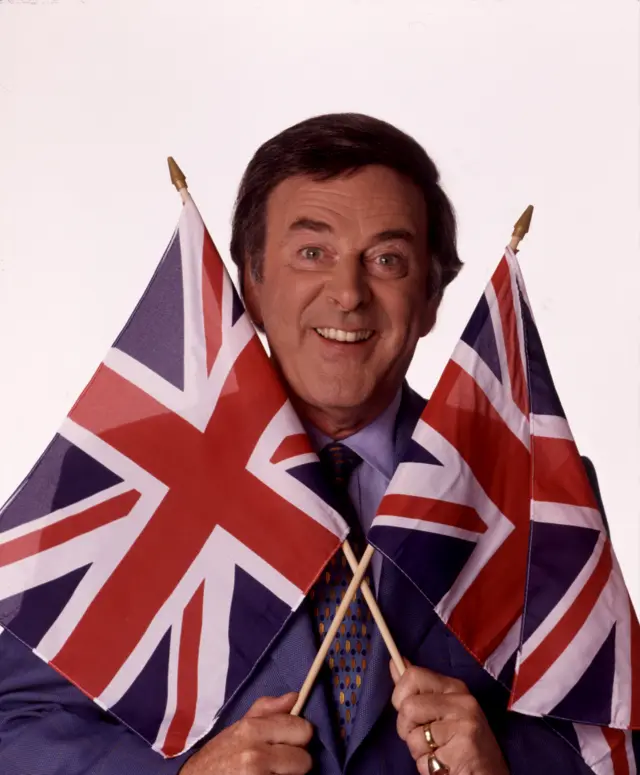Sir Terry Wogan holding two union flags