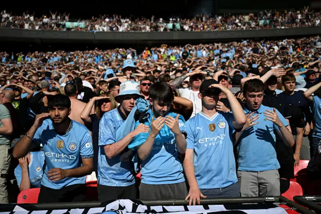 Fans of Manchester City react