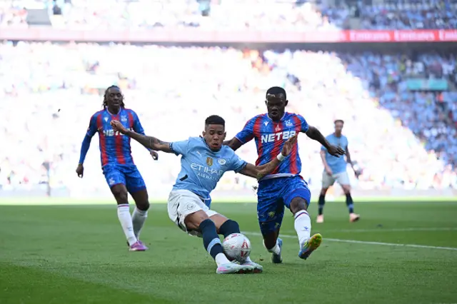 Savinho of Manchester City is challenged by Tyrick Mitchell