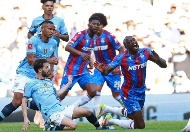 Manchester City's Bernardo Silva fouls Crystal Palace's Jean-Philippe Mateta before being shown a yellow