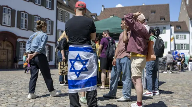 People supporting the Israeli singer Yuval at the 69th Eurovision Song Contest at the Muensterplatz in Basel