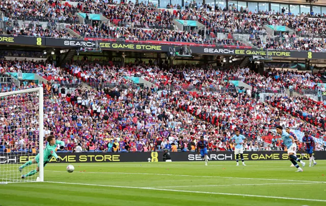 Dean Henderson of Crystal Palace saves a penalty from Omar Marmoush