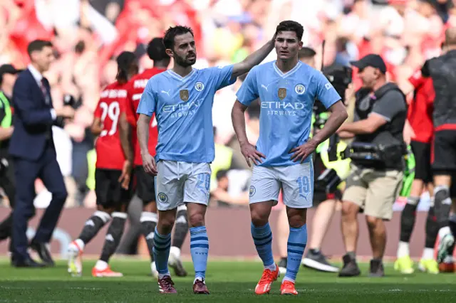Bernardo Silva (L) consols Manchester City's Argentinian striker Julian Alvarez after losing