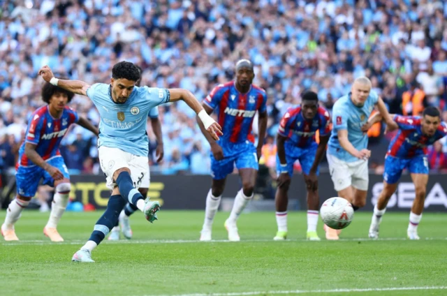 Manchester City's Omar Marmoush has his shot saved by Crystal Palace's Dean Henderson