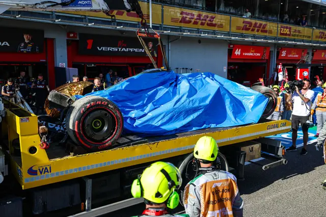 Yuki Tsunoda's car is taken back to the Red Bull garage