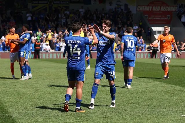 AFC Wimbledon players celebrate reaching the League Two play-off final