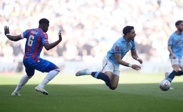 Crystal Palace's Marc Guehi (left) fouls Manchester City's Omar Marmoush
