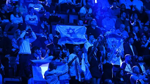 Some fans held up Israeli flags during Yuval Raphael's performance