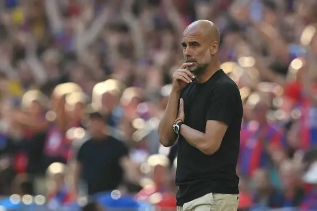 Pep Guardiola looks on