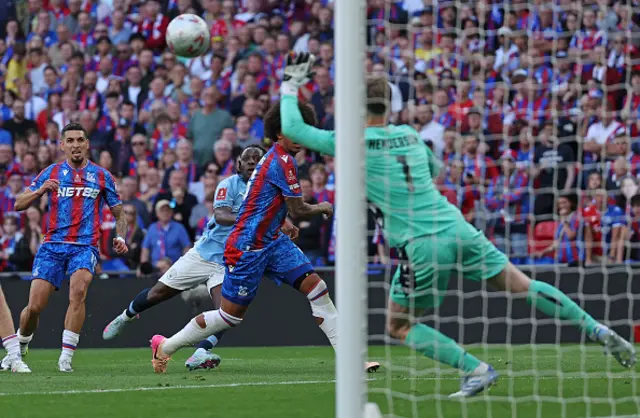 Jeremy Doku watches as Crystal Palace's English goalkeeper Dean Henderson saves his shot
