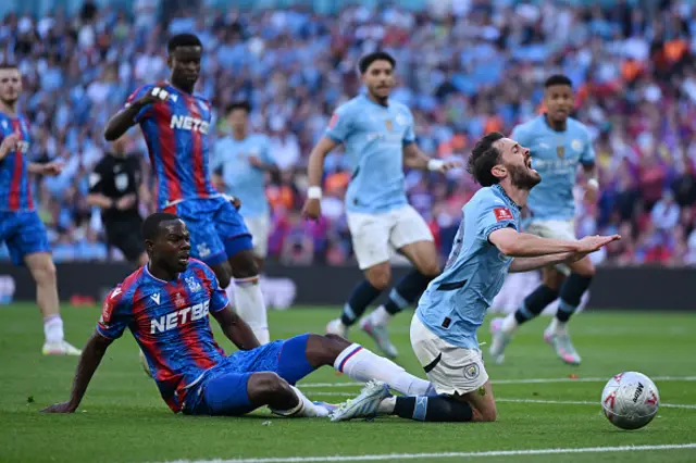 Bernardo Silva of Manchester City is fouled by Tyrick Mitchell
